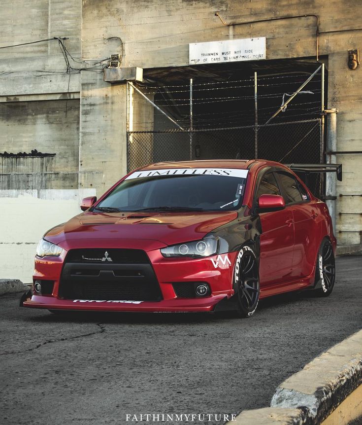 a red car parked in front of a building