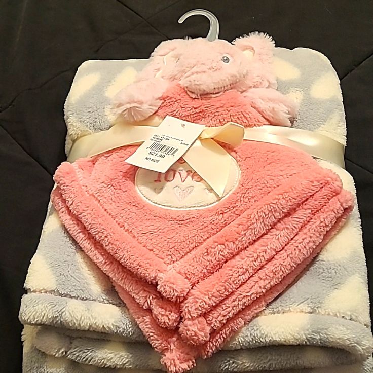 a pink teddy bear wrapped in a blanket