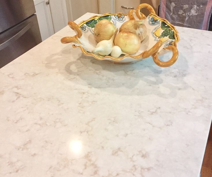 a bowl filled with onions sitting on top of a counter