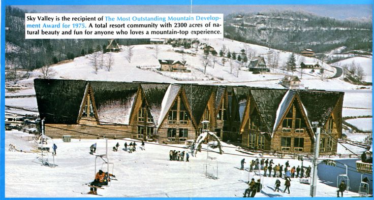 an aerial view of a ski lodge in the snow