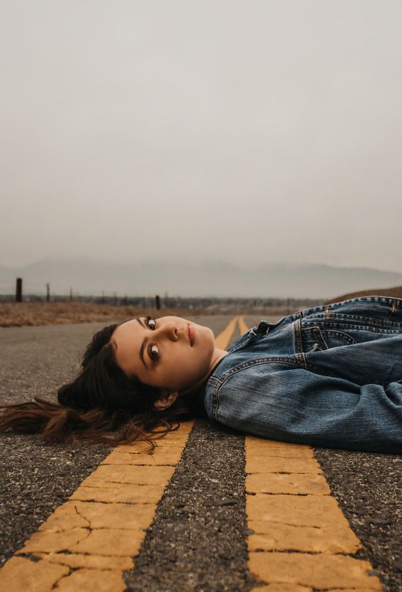 a woman laying on the ground with her eyes closed