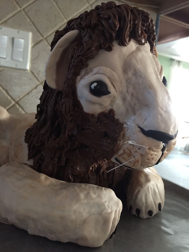 a lion statue sitting on top of a counter next to a white tile wall and floor