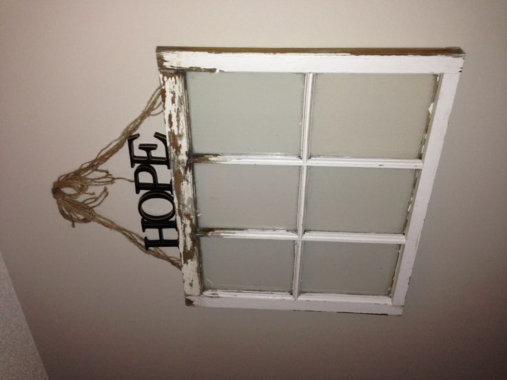 an old window with rope hanging from it's side and the word hope written on top