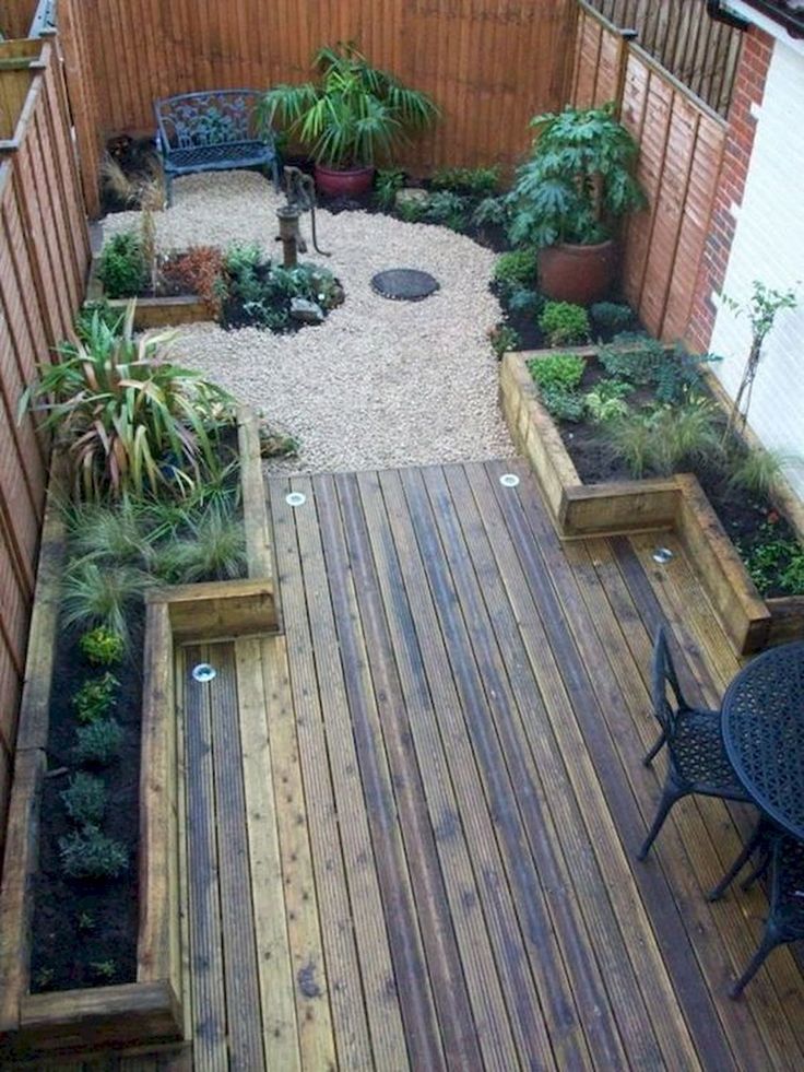 an outdoor patio with wooden decking and plants