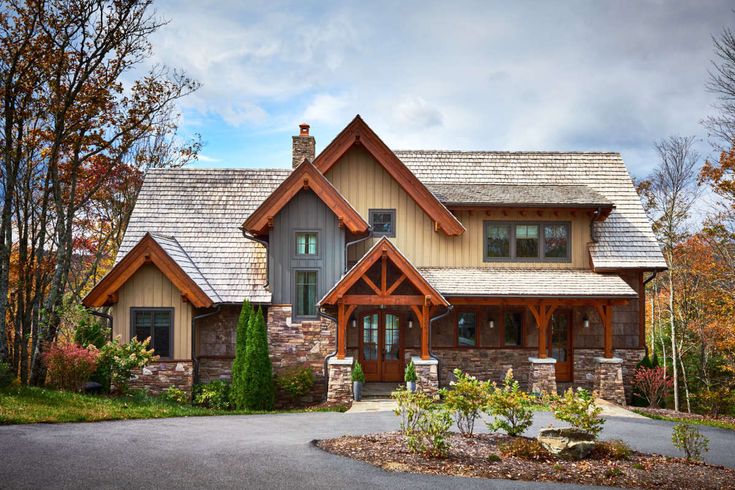 a large house with stone and wood accents