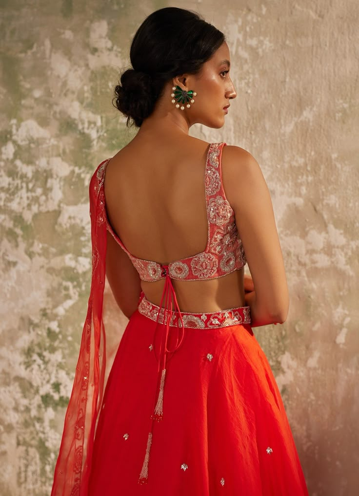 Unveil your inner elegance with the exquisite Red Embroidered Silk Organza Lehenga Set, a perfect blend of tradition and modernity. Crafted from pure silk organza, this ensemble features a red lehenga that exudes opulence through its all-over handwork motifs, adding a touch of luxury to every twirl. Paired with a delicately embroidered blouse, meticulously crafted with intricate aari handwork that showcases timeless artistry, the look is completed with a dupatta adorned with a heavily hand-embroidered border and motifs, elevating the ensemble to a new level of elegance. Perfect for a bride or bride-to-be on your special day, this outfit promises to make you the center of attention with its vibrant hue and breathtaking design. Composition : Dupatta & Lehenga - Pure Silk Organza, Blouse - Me Red Sleeveless Lehenga For Weddings, Sleeveless Red Lehenga For Wedding, Red Lehenga For Wedding, Red Sleeveless Traditional Wear For Wedding, Red Embroidered Ceremony Sets, Ceremonial Red Sets With Intricate Embroidery, Red Ceremony Sets With Intricate Embroidery, Red Embroidered Lehenga For Ceremony, Elegant Red Anarkali Set With Unstitched Blouse