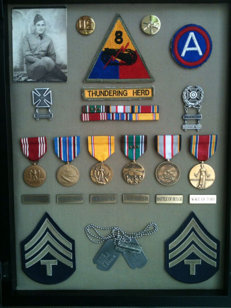 a shadow box is filled with medals and badges