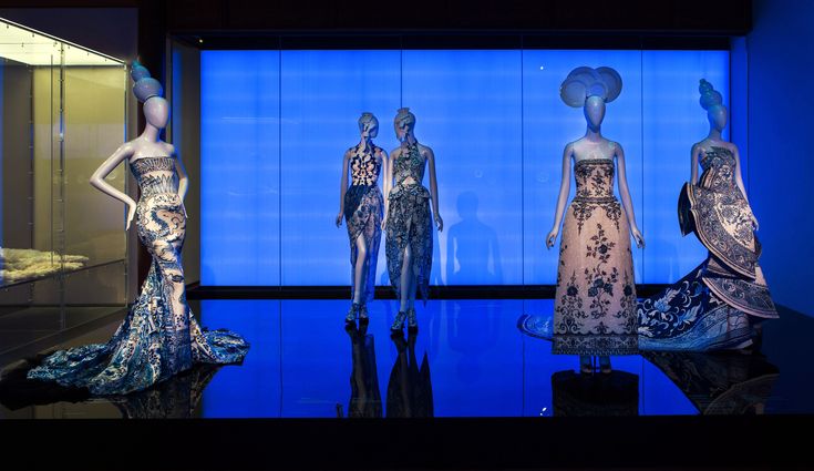 several mannequins dressed in evening gowns on display