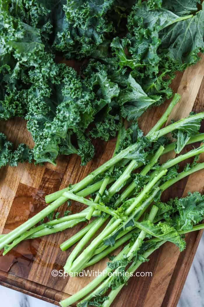 some green vegetables are laying on a cutting board