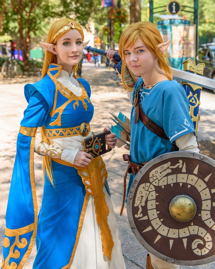 two people dressed in costumes standing next to each other