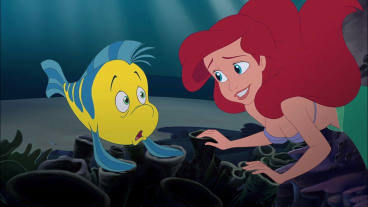 the little mermaid and her fish friend are looking at each other