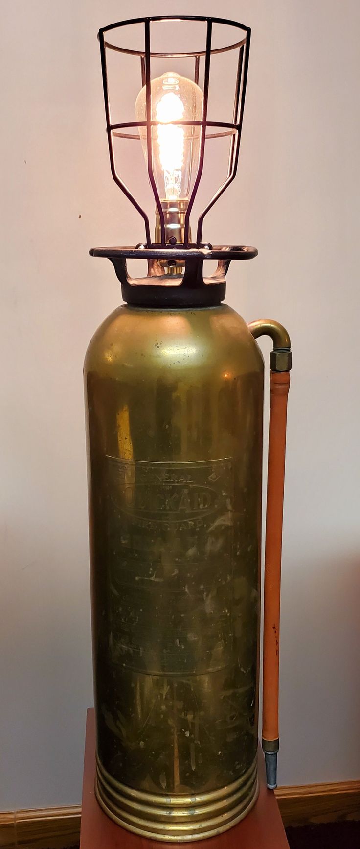 an old fashioned lamp sitting on top of a table