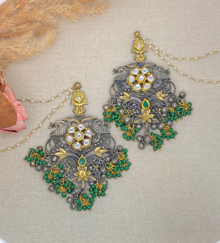 Oxidized statement earrings with pachi kundan work with light sahara(chain).  Dimensions-  Earrings length- 4.5 inches ,  width- 2.2 inches, Chain length- 7 inches Style tip- Pair it with any beautiful traditional outfits  and flaunt with Unique style of collection from us. Perfect match for Festival and Traditional wear.  Take Care Tips-  Kee away from perfume, Hair spray and. Moisture.  Store in dry place , Ziplock bag or Airtight box.    Clean with dry cloth.  Jewellery is the last thing you Festive Silver Chandelier Earrings With Tilla, Dual-tone Chandbali Jewelry For Party, Festive Silver Chandelier Earrings With Stone Work, Metal Chandbali Chandelier Earrings With Oxidized Finish, Festive Dual-tone Temple Jewelry Danglers, Oxidized Metal Chandbali Chandelier Earrings, Festive Oxidized Metal Chandelier Earrings, Party Oxidized Metal Jhumkas, Festive Dual-tone Kundan Danglers