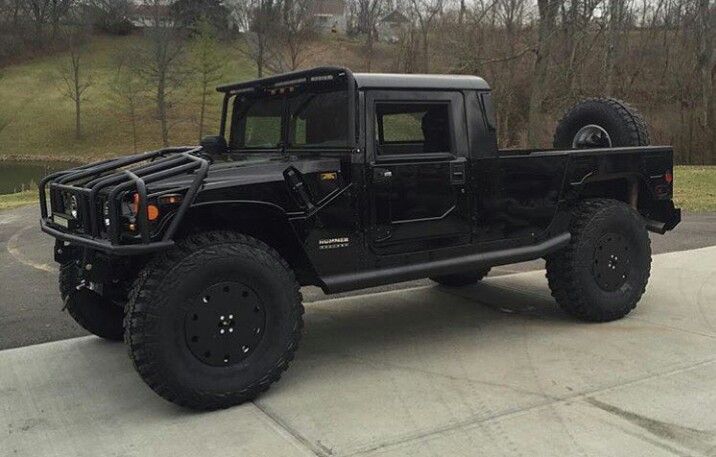 the black jeep is parked on the side of the road