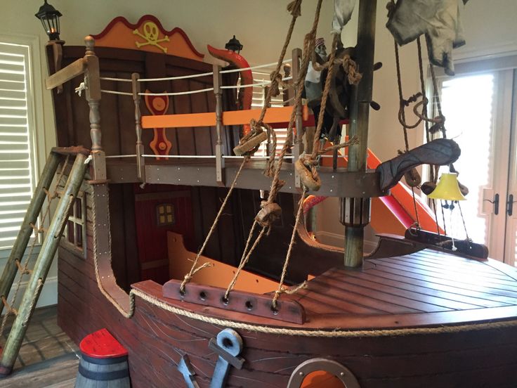 a wooden pirate ship with ropes and ladders