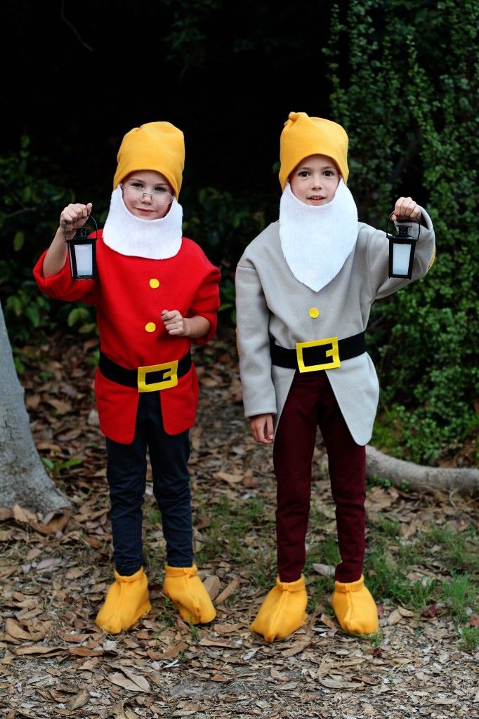 two children dressed up in costumes standing next to each other