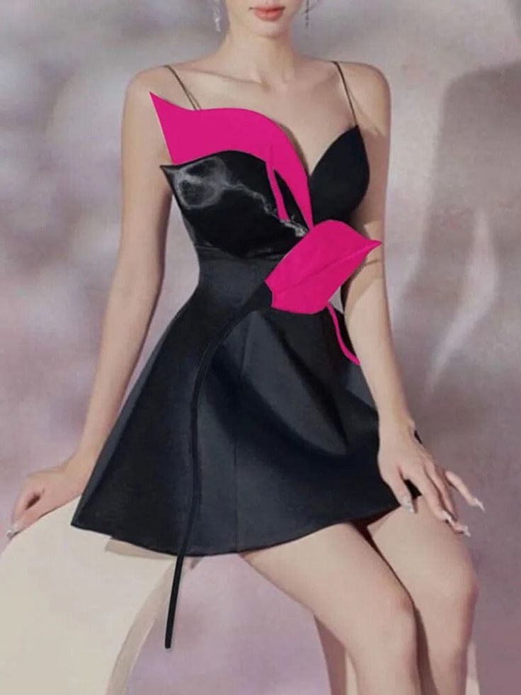 a woman in a black and pink dress posing for the camera