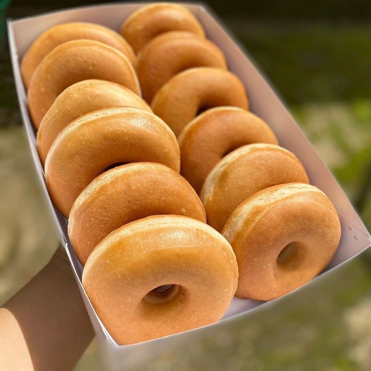 a box filled with lots of glazed donuts