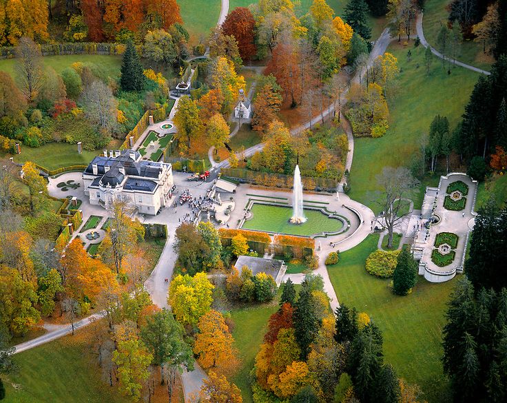 an aerial view of a large building in the middle of a park with lots of trees