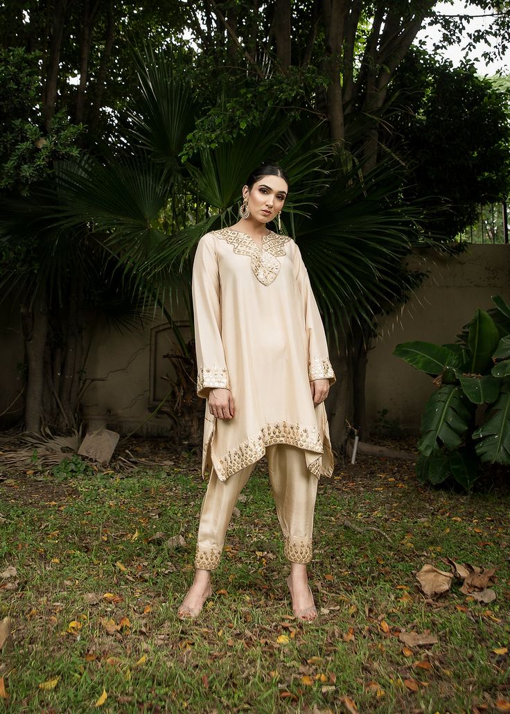 Ivory rawsilk kurta with skinny shalwar handworked with gota pati & dabka. Cream Cotton Silk Kurta With Resham Embroidery, Elegant Slub Silk Kurta With Mirror Work, Designer Cream Salwar Kameez With Gota Work, Designer Off White Kurta With Mirror Work, Off White Mirror Work Kurta For Designer Wear, Traditional Beige Kurta With Gota Work, Diwali Beige Kurta With Gota Work, Off White Designer Wear Kurta, Beige Gota Work Kurta For Diwali