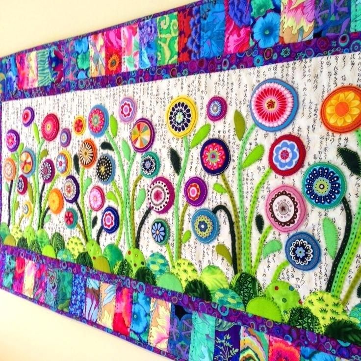 a colorful wall hanging with flowers on it