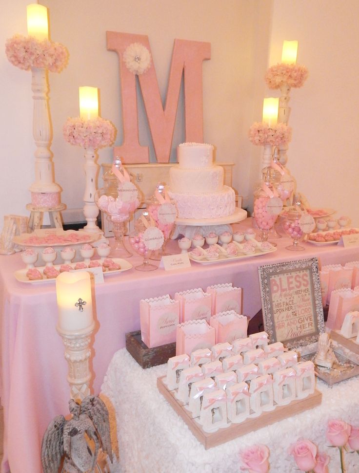 a table topped with lots of pink and white cakes