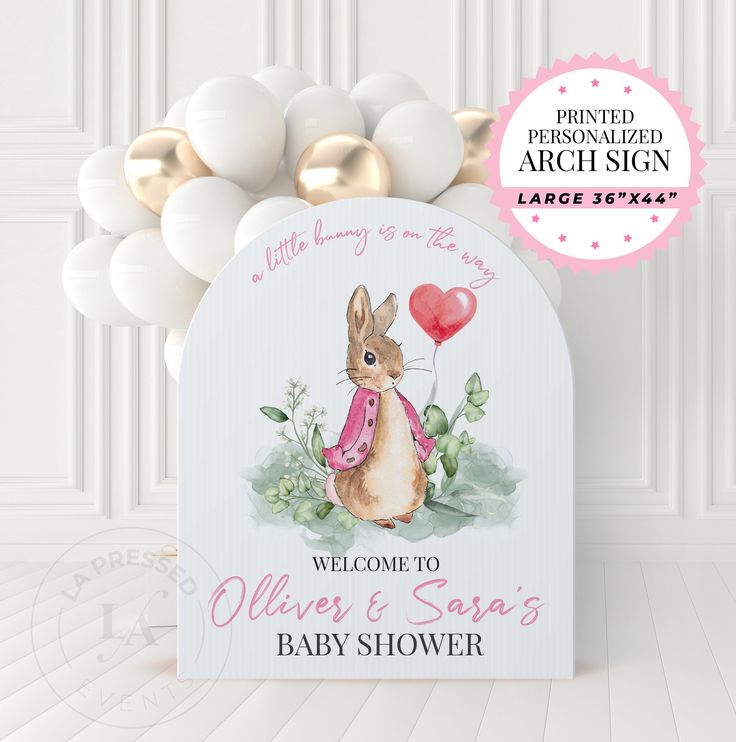 a baby shower sign with a bunny holding a heart shaped balloon in front of it