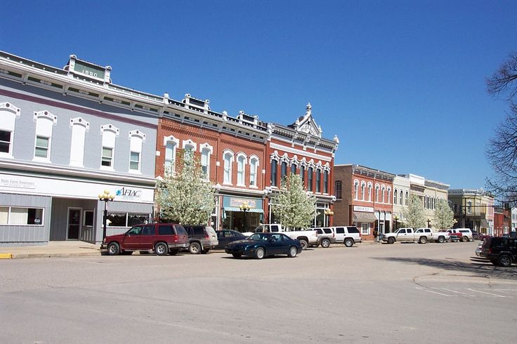 several cars parked on the street in front of buildings