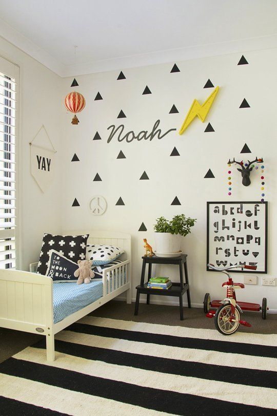 a child's bedroom with black and white decor