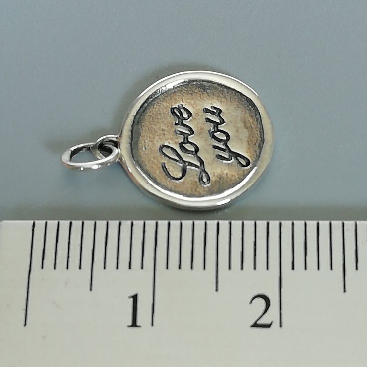 ▪︎ ONE sterling silver round charm with LOVE YOU inscribed on it. ▪︎ Size: 13 x 15 mm ( 17mm with hoop) Weight: 1.3 gm ▪︎ This is a multi functional charm and can be used with neck chains, ear hoops, bracelets, anklets, key chains etc. ▪︎ This pendant is handmade with hypoallergenic sterling silver, and is nickel free. Comes with a 925 mark for authenticity. ▪︎ Please note: Price listed is for ONE charm. This pendant comes WITHOUT the chain, however, you can add a snake neck chain, bracelet chai Inspirational Charms Jewelry For Anniversary, Inspirational Silver Jewelry For Birthday, Meaningful Hand Stamped Sterling Silver Charm Necklaces, Meaningful Hand Stamped Sterling Silver Charm Necklace, Gift Charm Necklace With Stamped 925 Pendant, Stamped 925 Pendant Charm Necklace As Gift, Stamped 925 Charm Pendant Necklace For Gift, Stamped 925 Silver Pendant Charm Necklace For Gift, Silver Hand Stamped Meaningful Charm Necklace