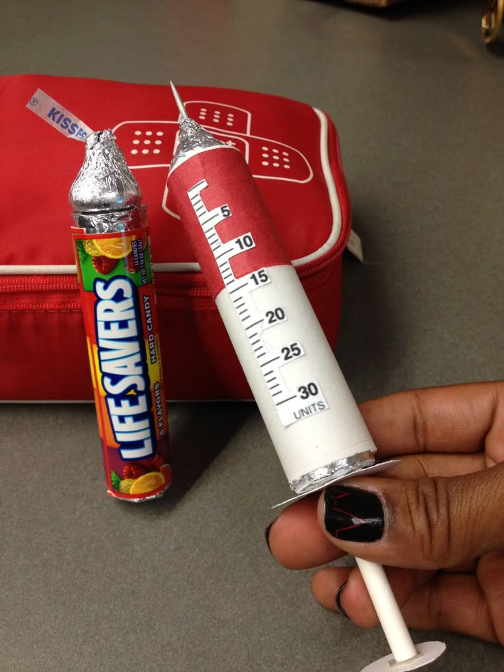 someone is holding up a tube of toothpaste and an orange case behind it