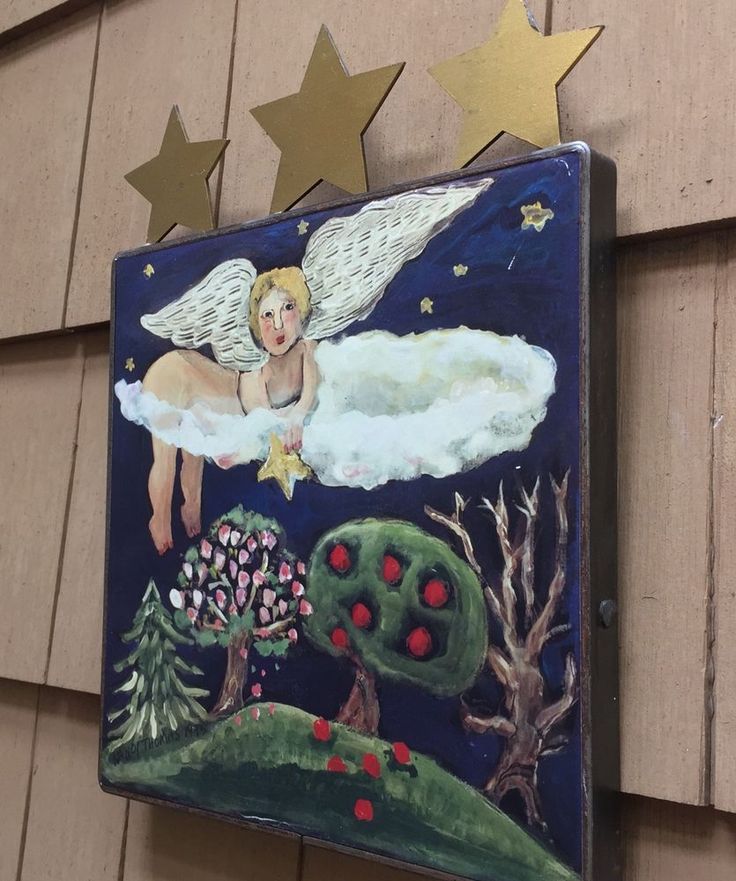 a painting on the side of a building with stars above it and an angel in the sky