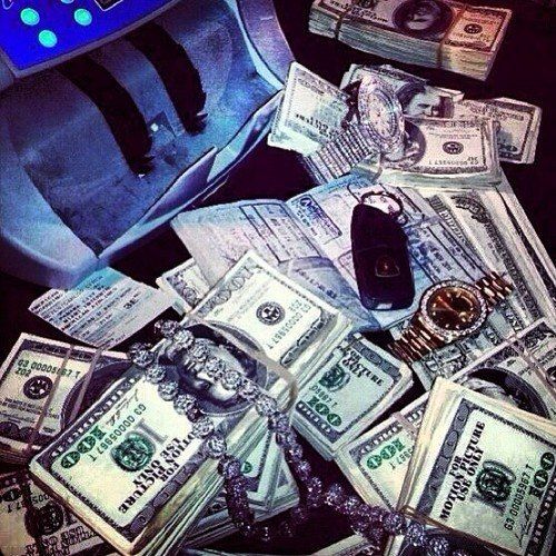 a bag full of money sitting on top of a table next to a cell phone