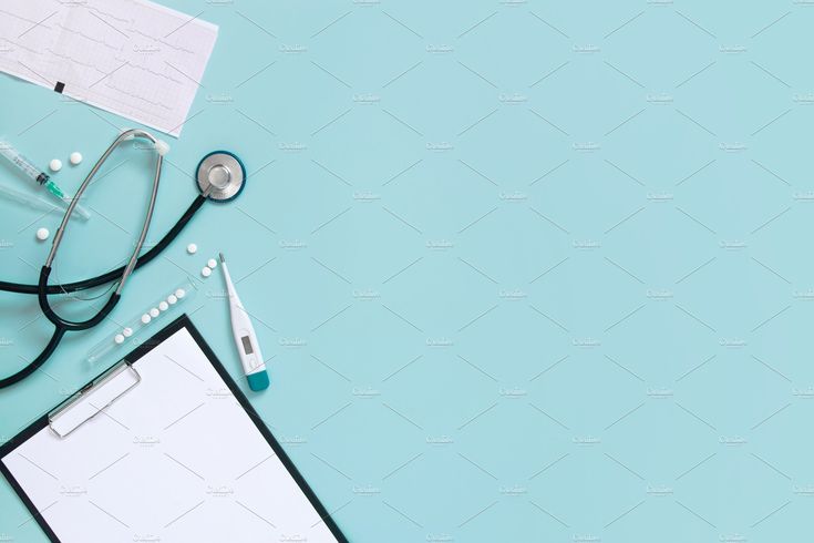 an overhead view of medical equipment on a blue background with copy - up paper and stethoscope