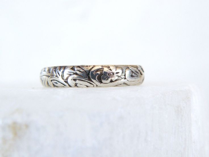 What a sweet old treasure. This hand engraved sterling silver feminine floral leaf vine band makes a sweet wedding band or right hand ring. It is delicate, feminine, and perfect for stacking or wearing alone. There are initials inside the band. It measures about 4.5-mm Size 9 - a jeweler might be able to size it. I would contact the jeweler and ask them to look at the photos of this ring.  Marked Sterling  Weight 2.9 grams. This band is in very good vintage condition. May need to be polished. Engraved Vintage Stackable Promise Rings, Wedding Bands With Etched Detail And Adjustable Fit, Engraved Stackable Toe Rings For Wedding, Adjustable Etched Wedding Bands, Wedding Adjustable Etched Bands, Dainty Engraved Wedding Ring, Elegant Stamped White Gold Engraved Ring, Heirloom Style Silver Stackable Rings, Heirloom Silver Stackable Rings