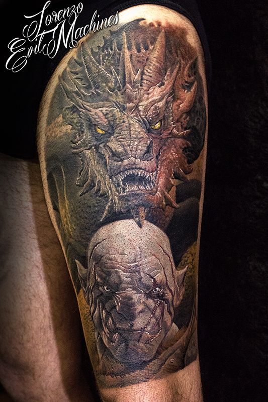 a man's arm with tattoos on it and an image of two demonic creatures