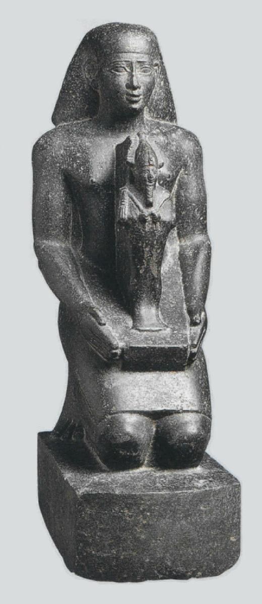 an ancient statue is shown in this black and white photo, it appears to be the egyptian god horus