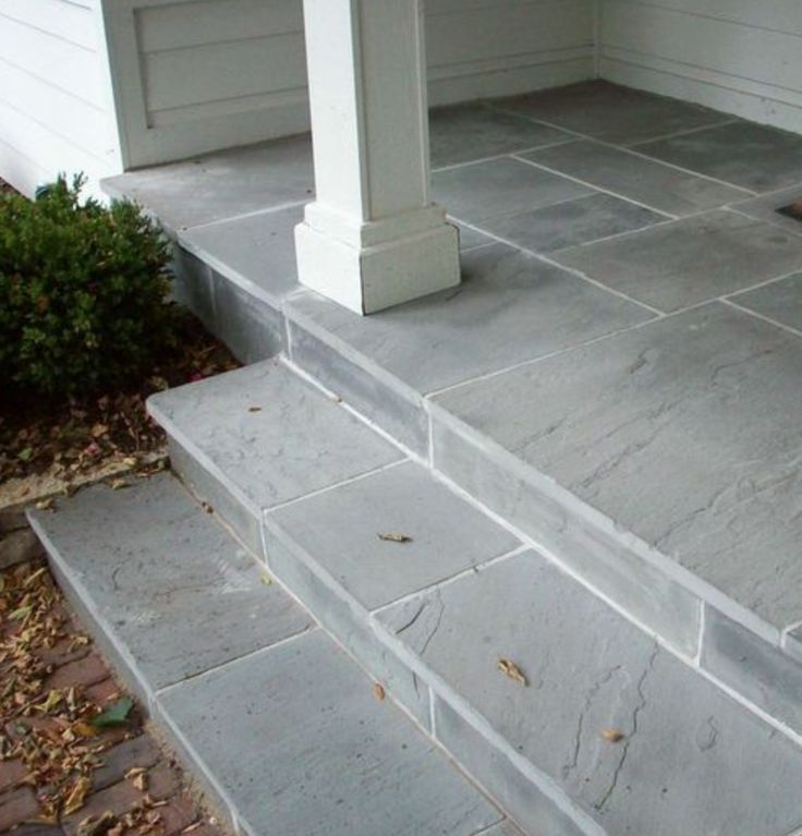 a porch with steps leading up to the front door