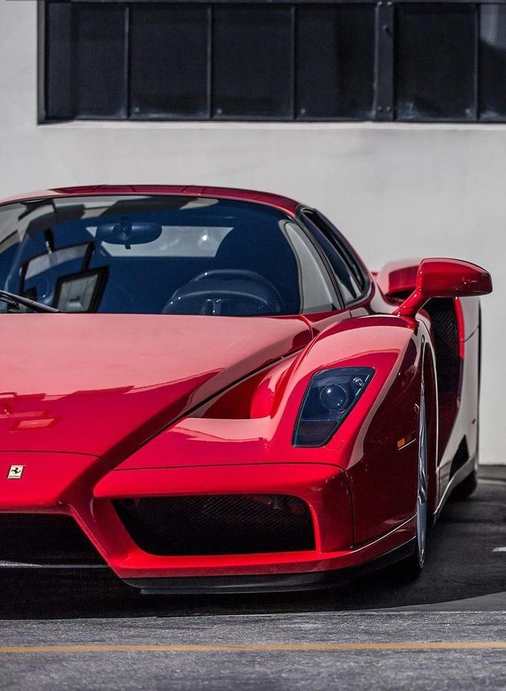 a red sports car parked in front of a building