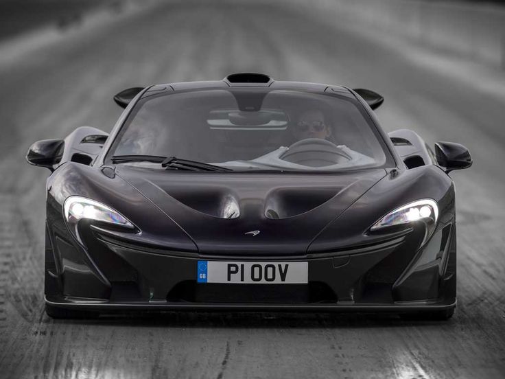 a black sports car driving down a race track