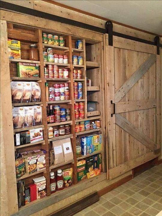 an open pantry with lots of food in it and sliding doors on the side wall