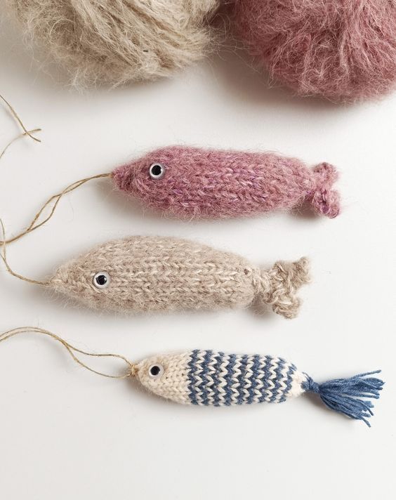 three knitted fish ornament displayed on white surface