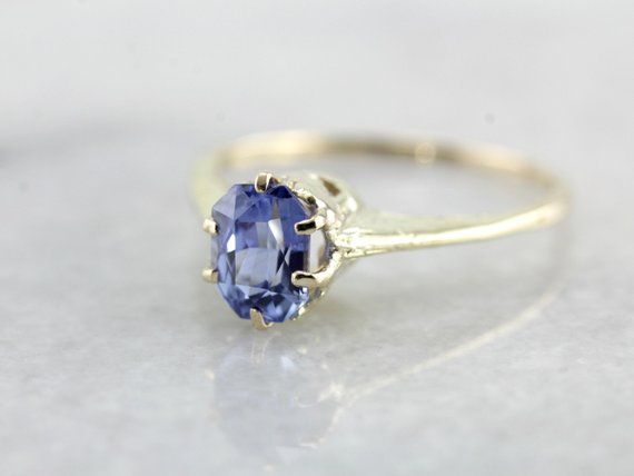 This is a stunning early 1900's green gold engagement ring that has a rich luster! Utterly stunning, this vintage gold piece is lightly chased along the tall, polished shoulders. Green gold is created when gold is alloyed with sterling silver. The center stone of this incredible vintage setting is one of our loveliest sapphires! Blue as an October sky and filled with shine, this amazing stone is a perfect choice for this colorful setting! This ring would be amazing as an engagement ring, or simp Timeless Sapphire Wedding Ring, Classic Oval Sapphire Ring, Classic Oval Sapphire Ring With Prong Setting, Classic Sapphire Baguette Cut Ring, Classic Sapphire Birthstone Ring With Gemstone, Classic 14k Gold Emerald-cut Sapphire Ring, Classic 14k Gold Emerald Cut Sapphire Ring, Classic Sapphire 14k Gold Ring, Hallmarked Classic Sapphire Ring