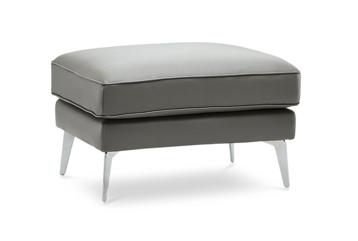 a grey ottoman sitting on top of a white floor