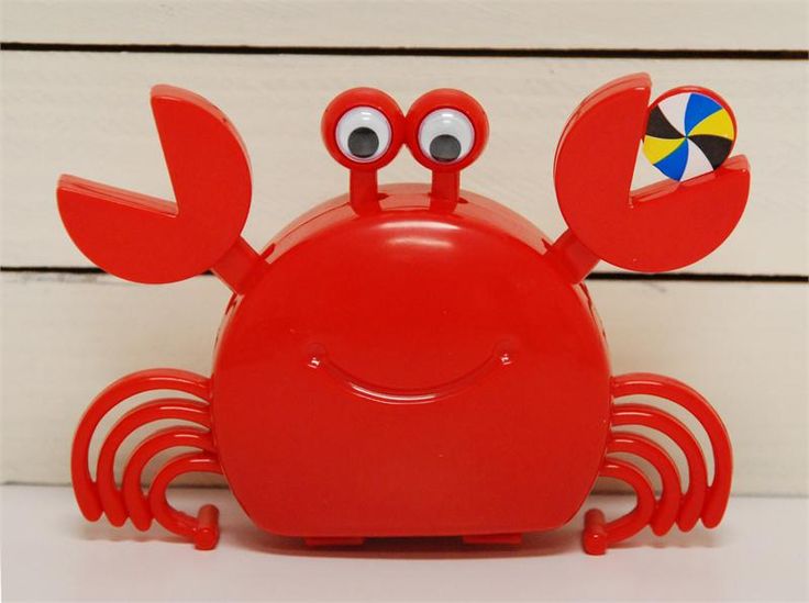 a red plastic crab with eyes and legs