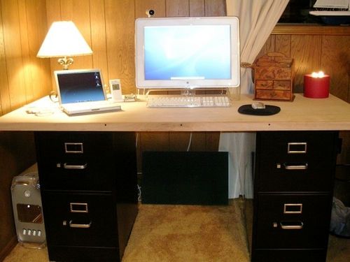 a computer desk with a laptop on top of it and a lamp next to it