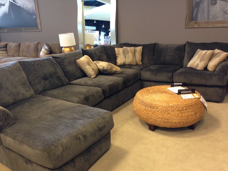 a living room filled with lots of couches and pillows on top of each other