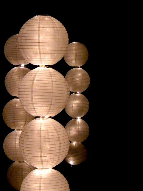 several white paper lanterns hanging from the ceiling