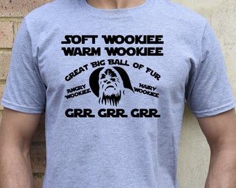 a man wearing a gray t - shirt that says soft wookiee warm wookiee great big ball of fur