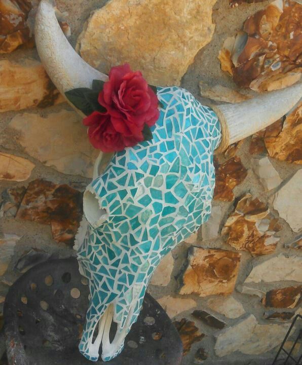 a cow skull with a red flower on it's head is featured in an instagram